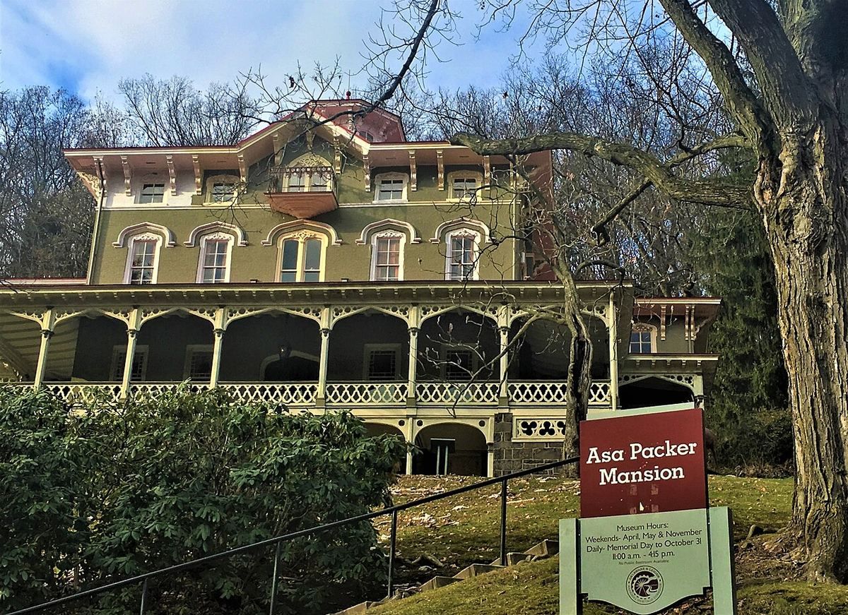 The Asa Packer Mansion, an ornate Italianate house with a deep wrap-around porch, seen across its lawn.