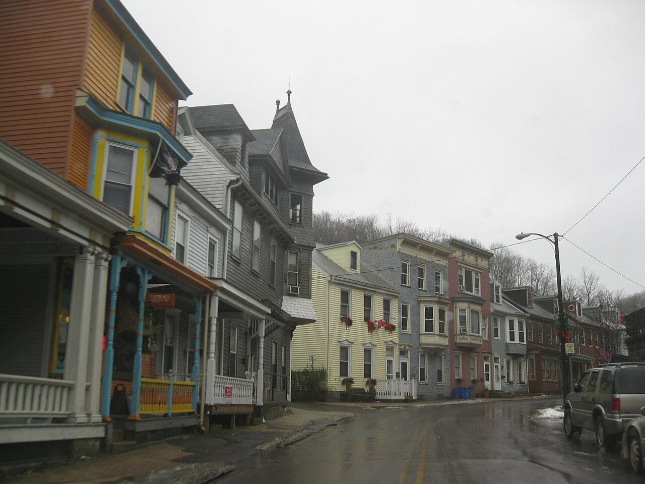 Broadway in Jim Thorpe on a wet day — painted storefronts and narrow Victorian buildings climbing the hill.