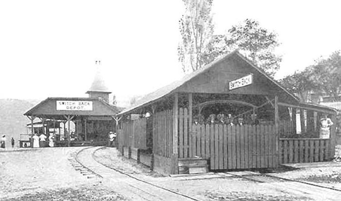 The Switchback Railroad's Mauch Chunk station, a long timber shed with passengers waiting outside.