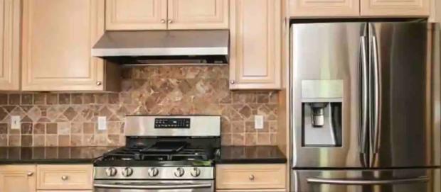 Custom kitchen with solid maple cabinets, granite counters, gas range and stainless steel refrigerator.